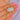 Opal flower pendant, angled held view of the cabochon and open curls